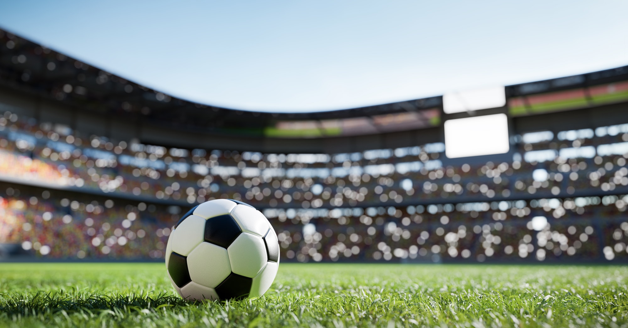 Football soccer ball on grass field on stadium
